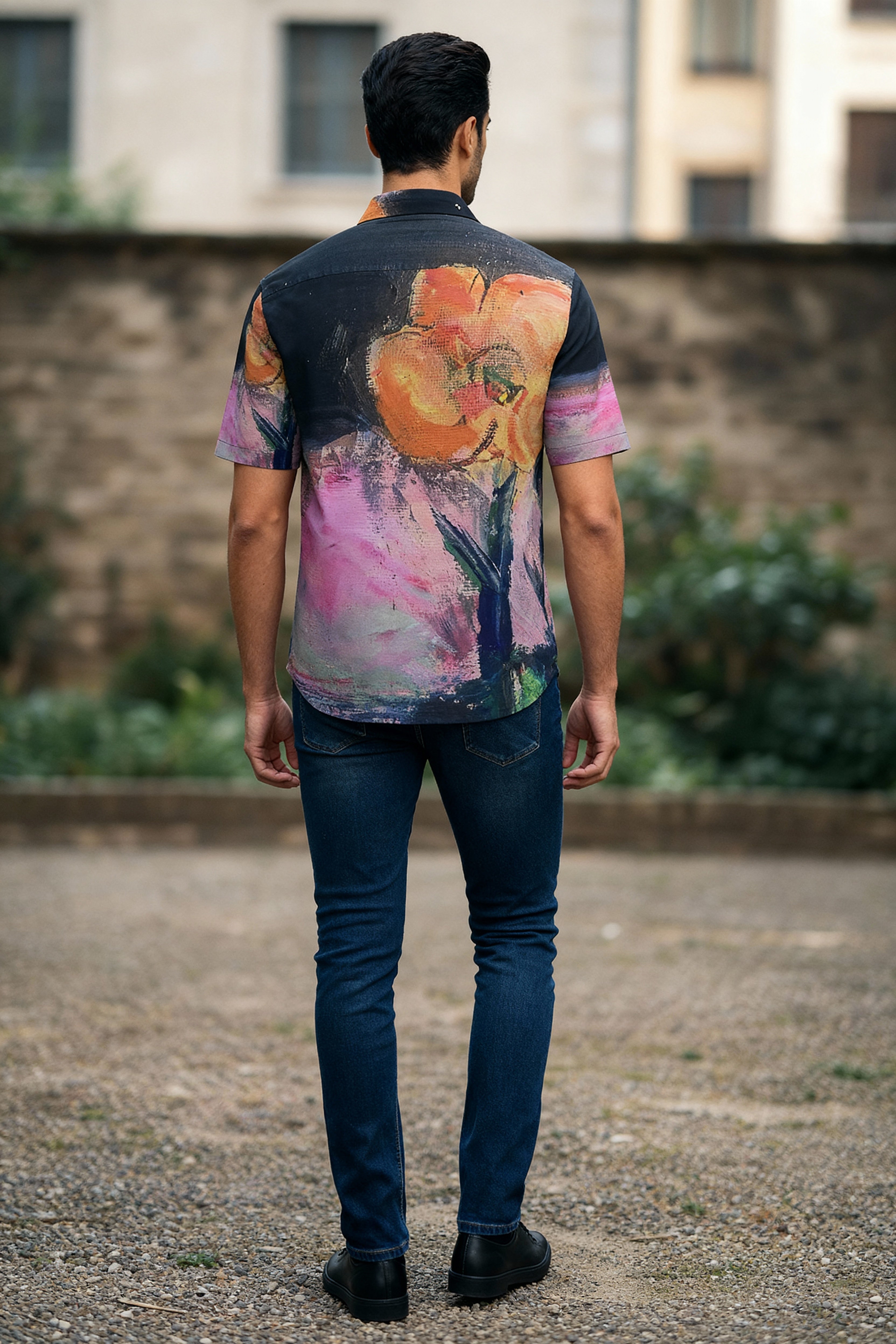 Person wearing a colorful shirt with floral patterns outdoors.
