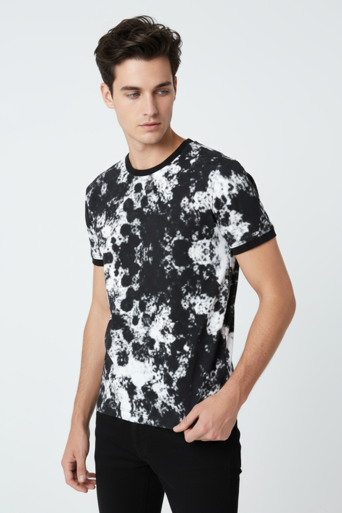 Man wearing a black and white floral patterned t-shirt on a white background