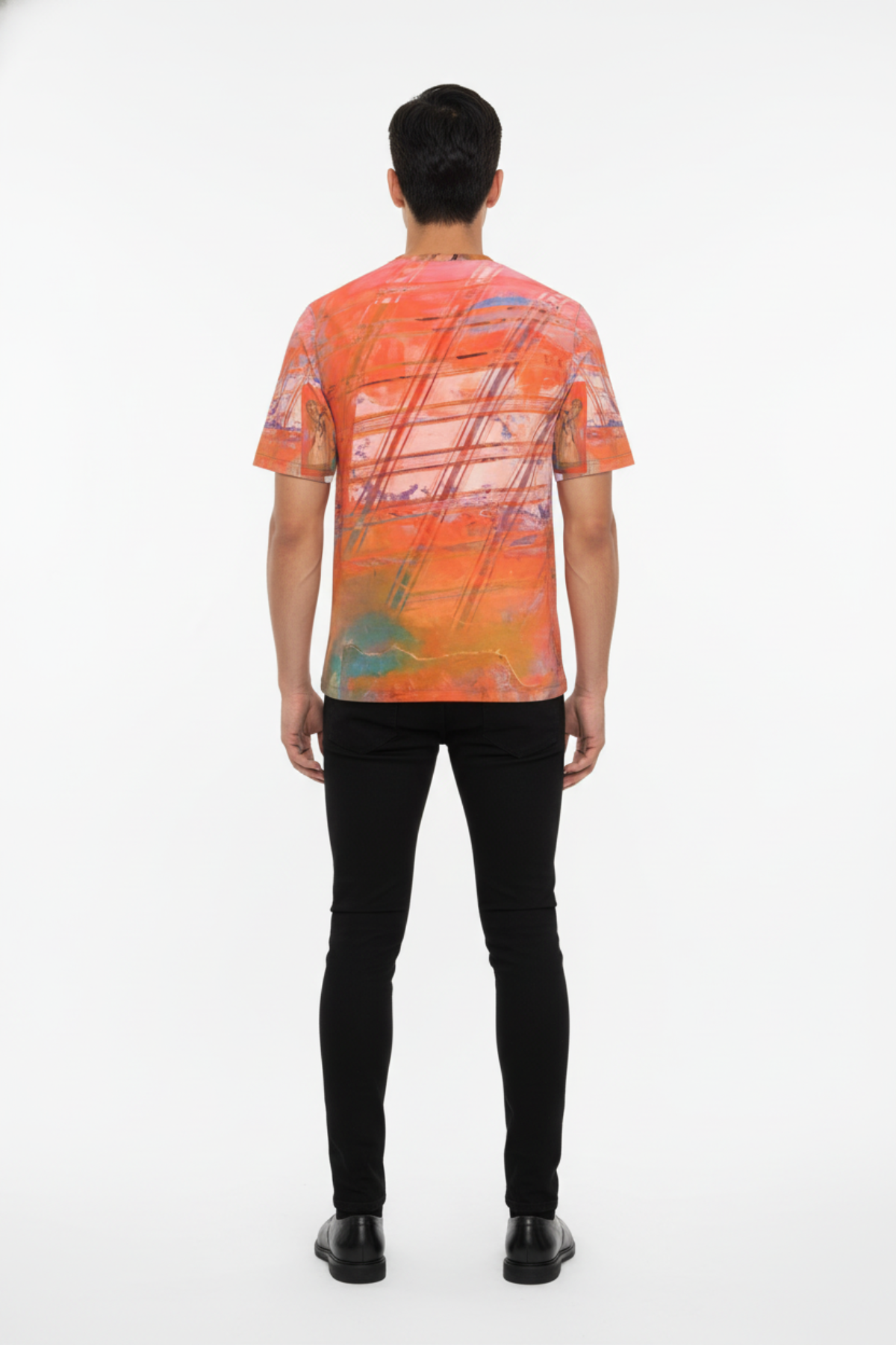 Person wearing a colorful abstract patterned shirt on a white background