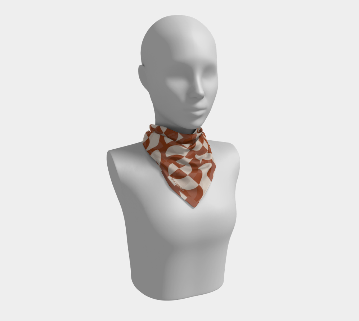 Mannequin wearing a patterned scarf on a white background