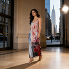 Woman in a colorful dress standing in an urban setting with cityscape in the background