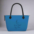 Blue handbag with black handle and 'Fine Art by Are' text on a gray background