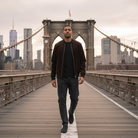 Man walking on the Brooklyn Bridge with city skyline in the background