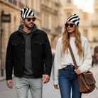 Two people walking on a street, wearing matching striped beanies and sunglasses.