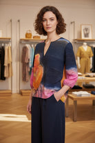 Woman wearing a colorful dress in a clothing store