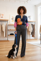 Woman in a stylish outfit with a dog in a clothing store