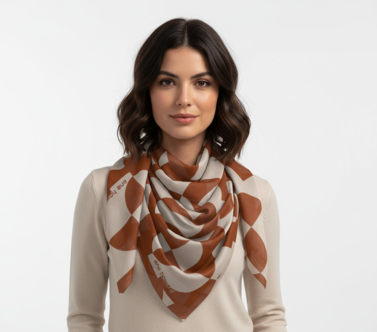 Woman wearing a patterned scarf on a plain background