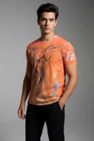 Man wearing an orange t-shirt with graphic design on a gray background