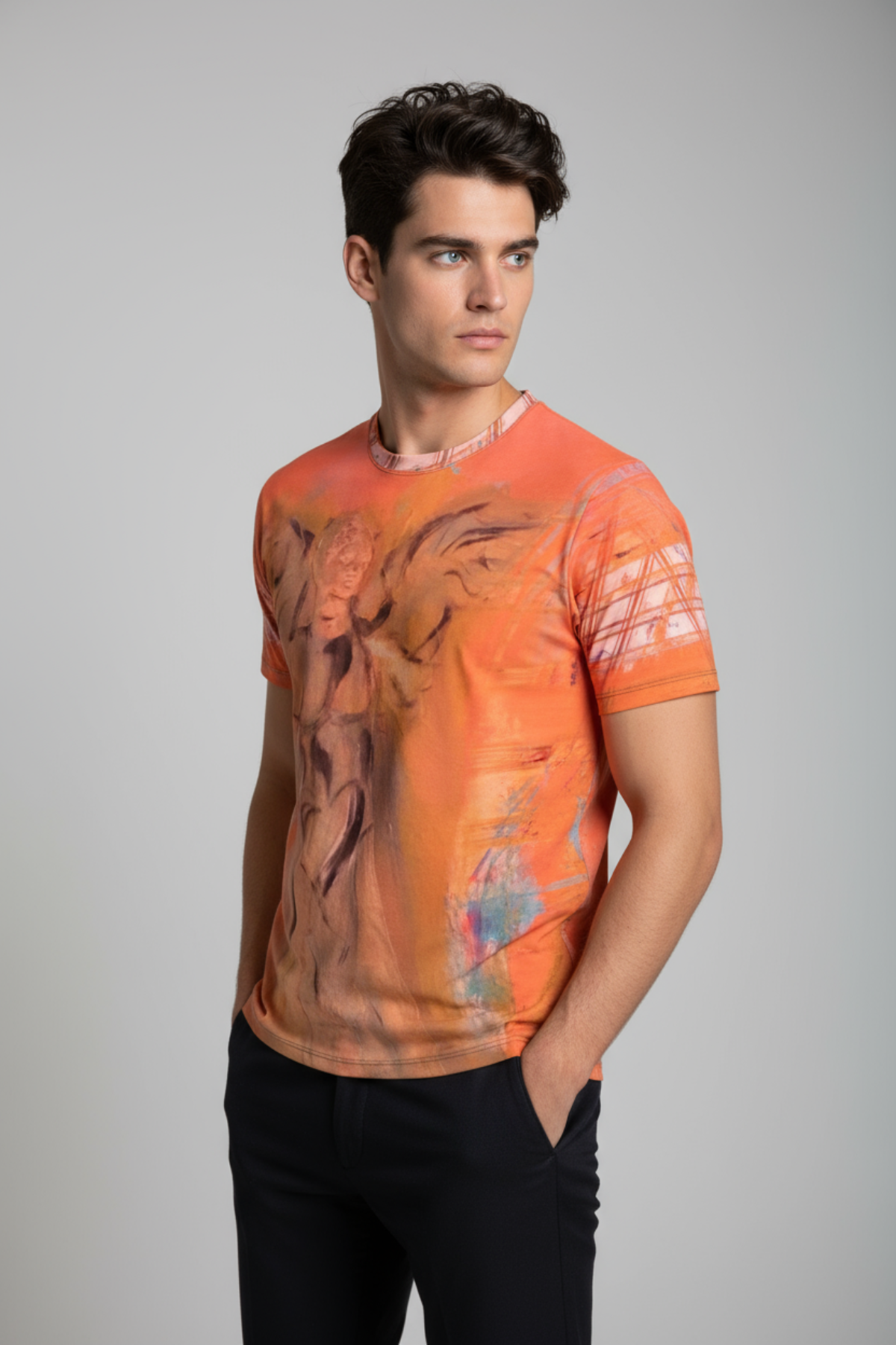 Man wearing an orange tie-dye t-shirt against a gray background