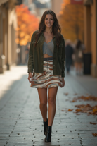 Woman walking on a street with autumn foliage in the background