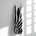Black and white zebra-striped dress on a hanger against a white wall with sunlight casting shadows.
