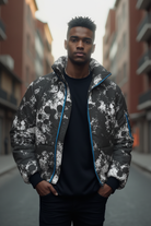 Man wearing a black and white patterned jacket on a city street